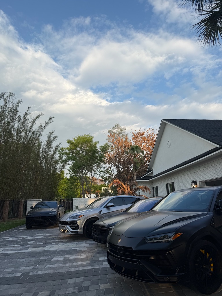 Three Lamborghini Urus SUVs detailed in an Orlando, FL driveway by Drip Mobile Detailing